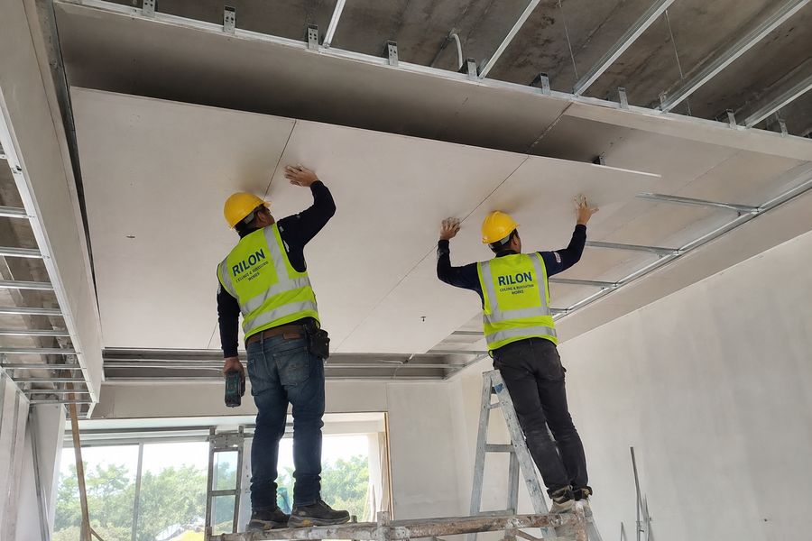 RILON crew installing gypsum board ceiling on site